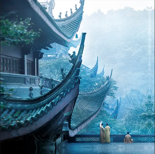 Upturned temple eaves layered against the misty wooded slopes at Lingyin