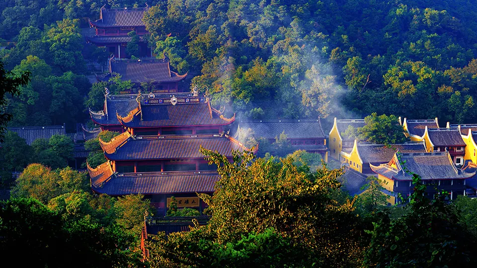 Lingyin Temple's tiled halls surrounded by wooded hills and drifting incense smoke